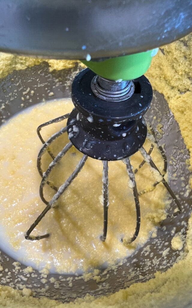 Raw milk in kitchen aid being whipped to butter 